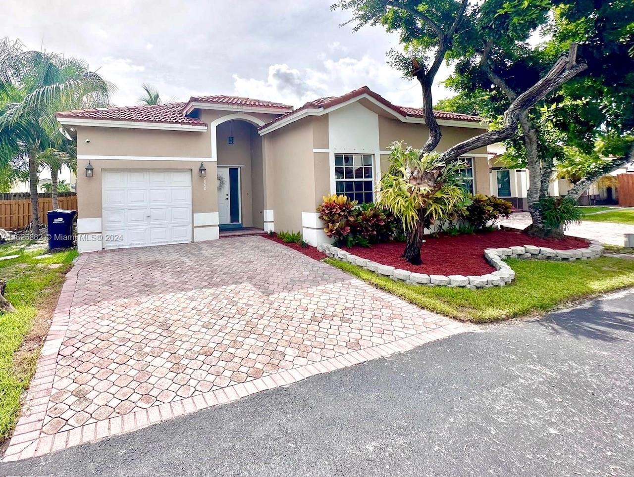 a view of a house with a yard and garage