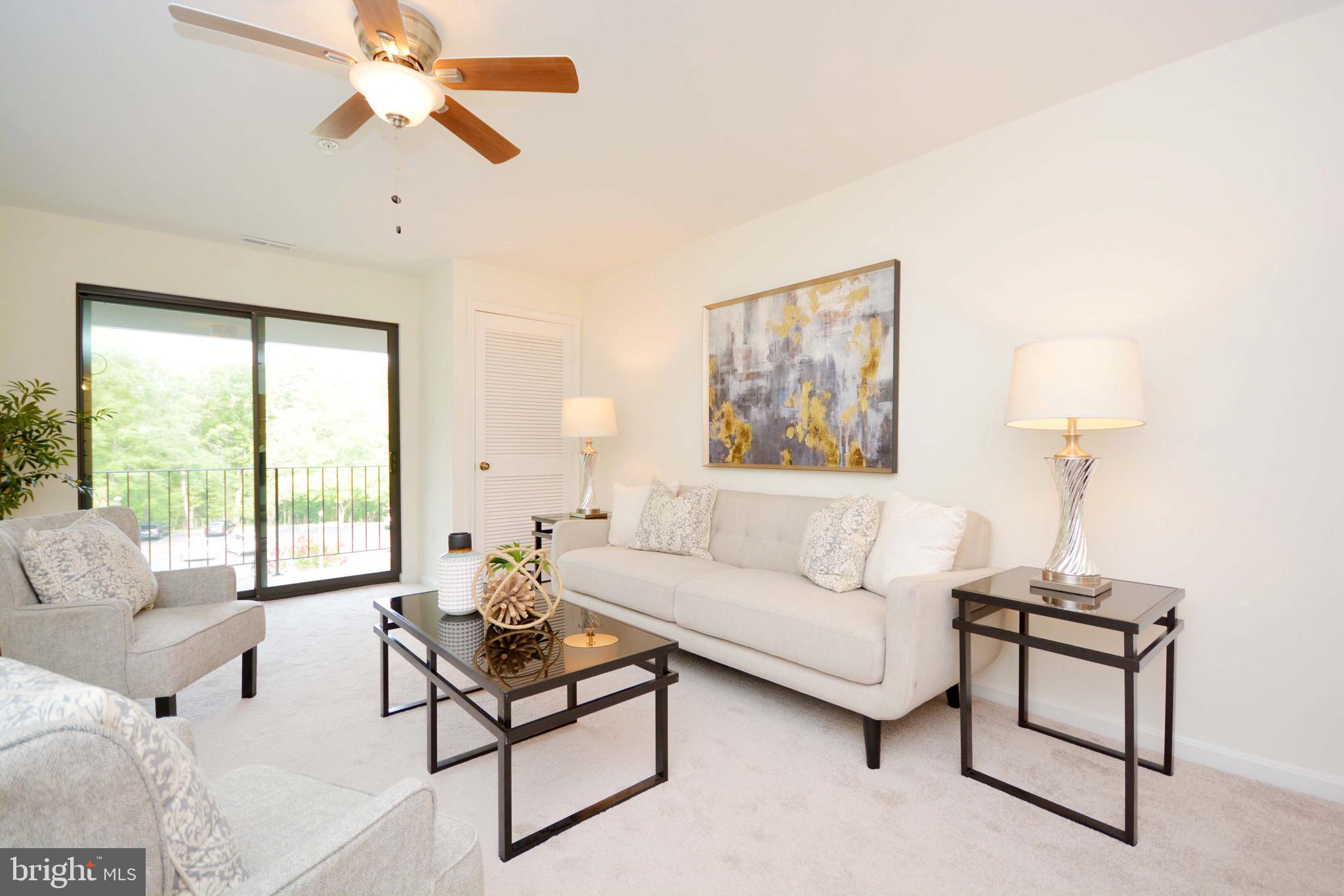 a living room with furniture a window and a flat screen tv