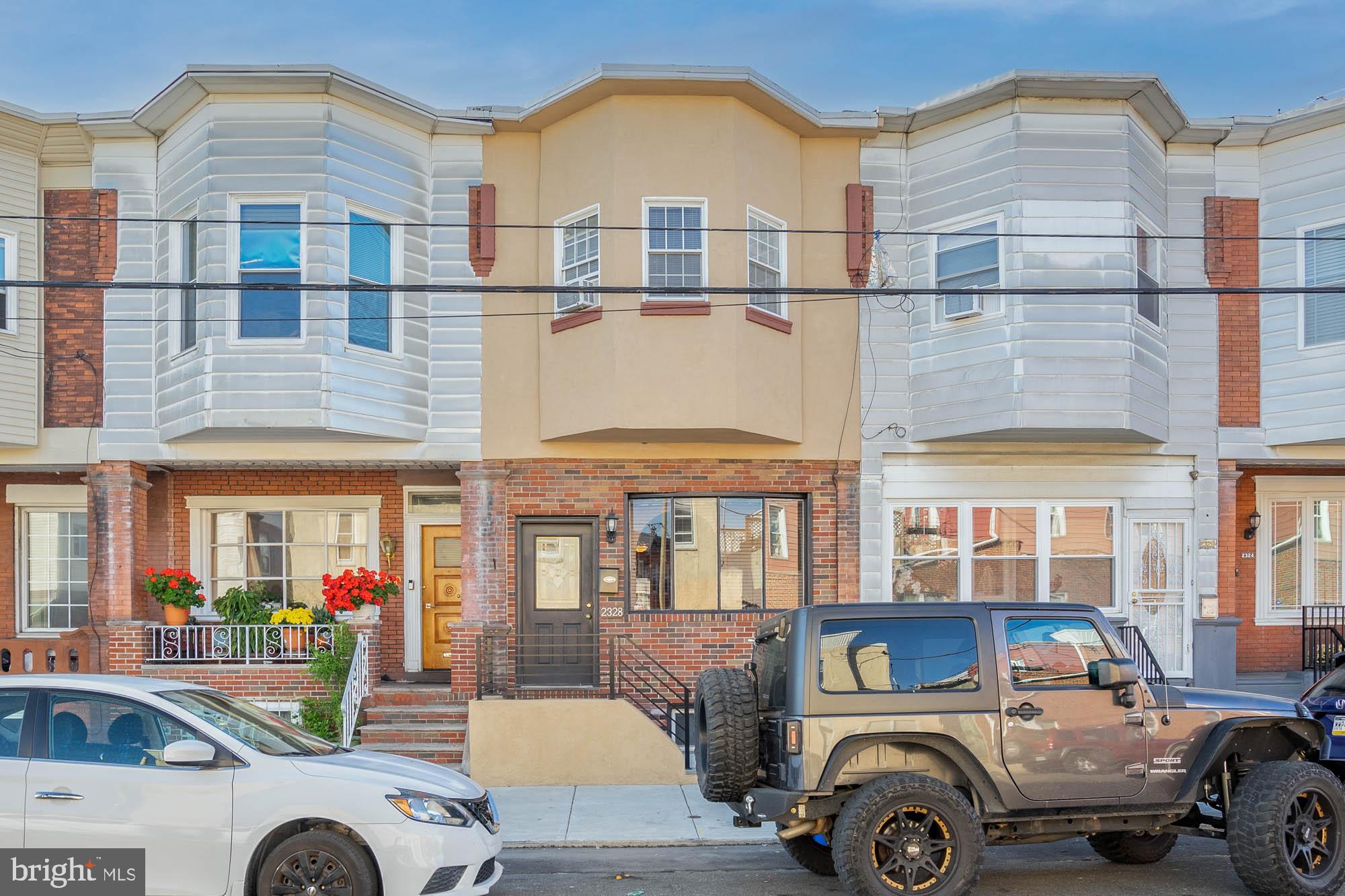 a front view of a residential apartment building with a yard