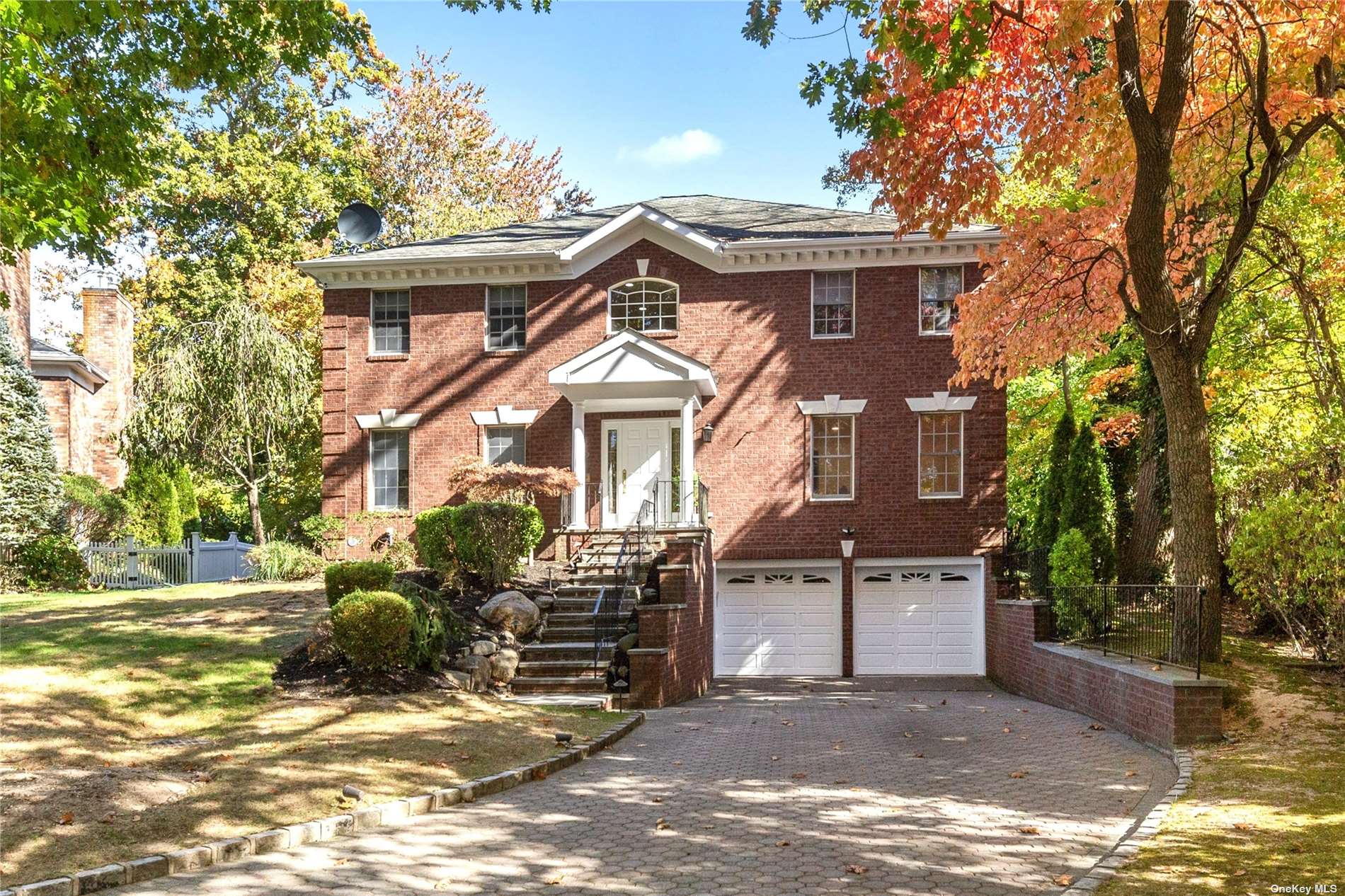 a view of a house with a patio and a yard