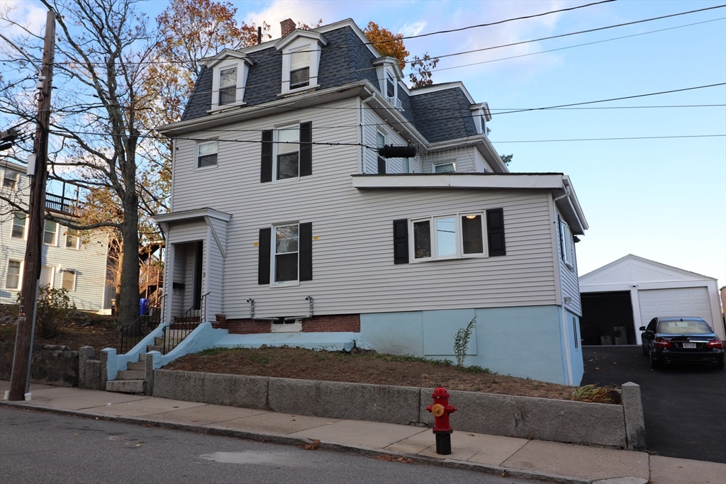 a front view of a house with a parking