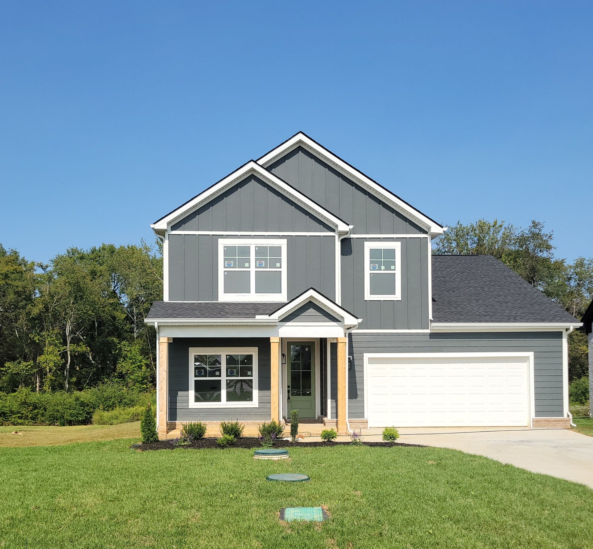 a front view of a house with a yard and porch