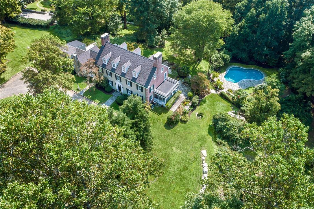 an aerial view of a house with garden space and street view