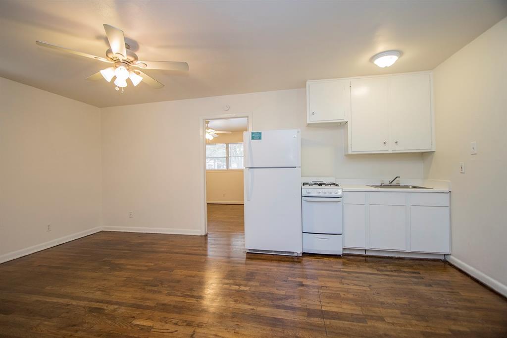 a view of a kitchen with a stove cabinets and wooden floor