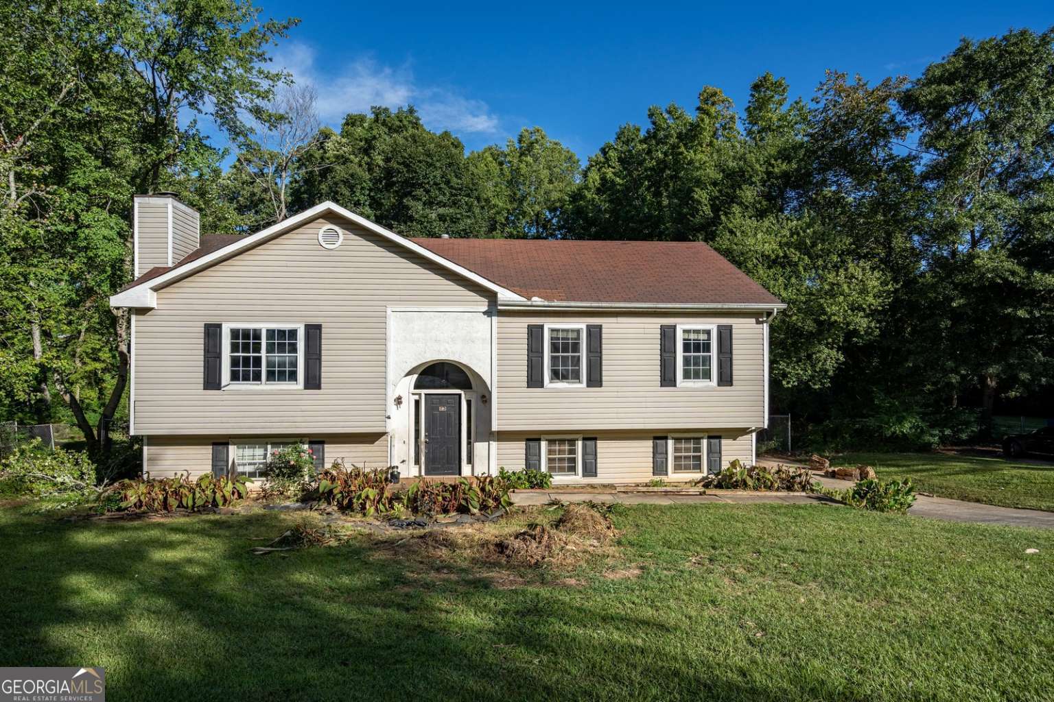 a front view of a house with a garden