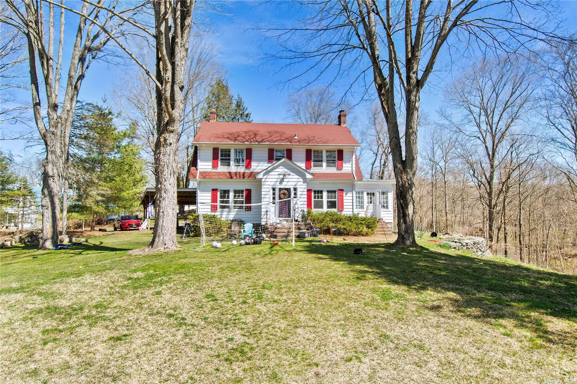 a view of a house with a yard and sitting area