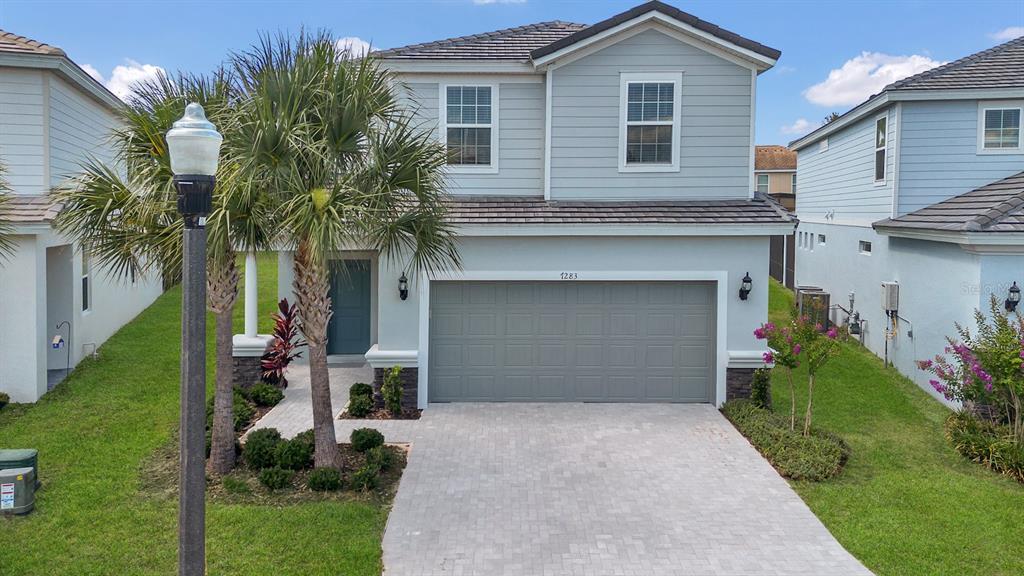 a front view of a house with a yard and garage