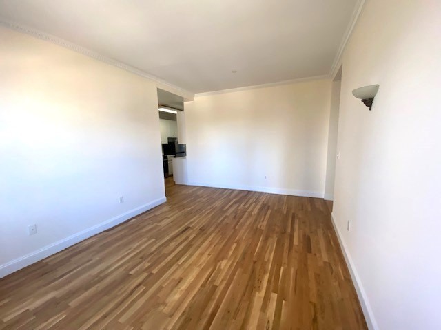 a view of a room with wooden floor