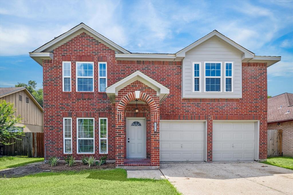 front view of brick house with a yard