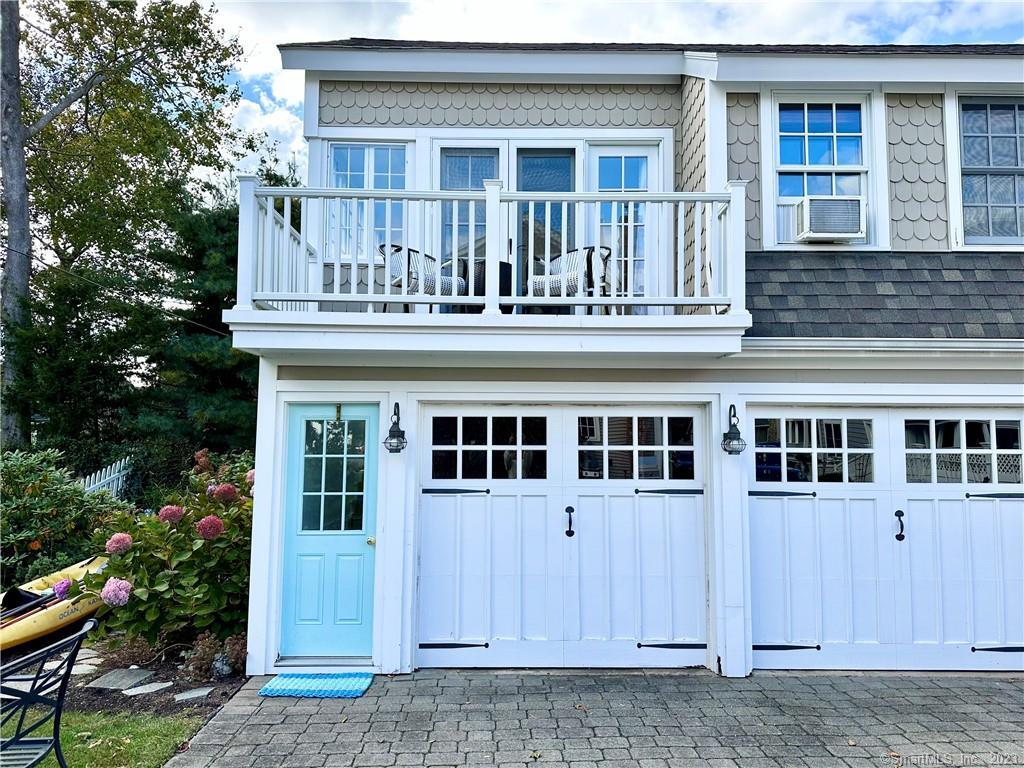 a view of a house with wooden fence and a porch