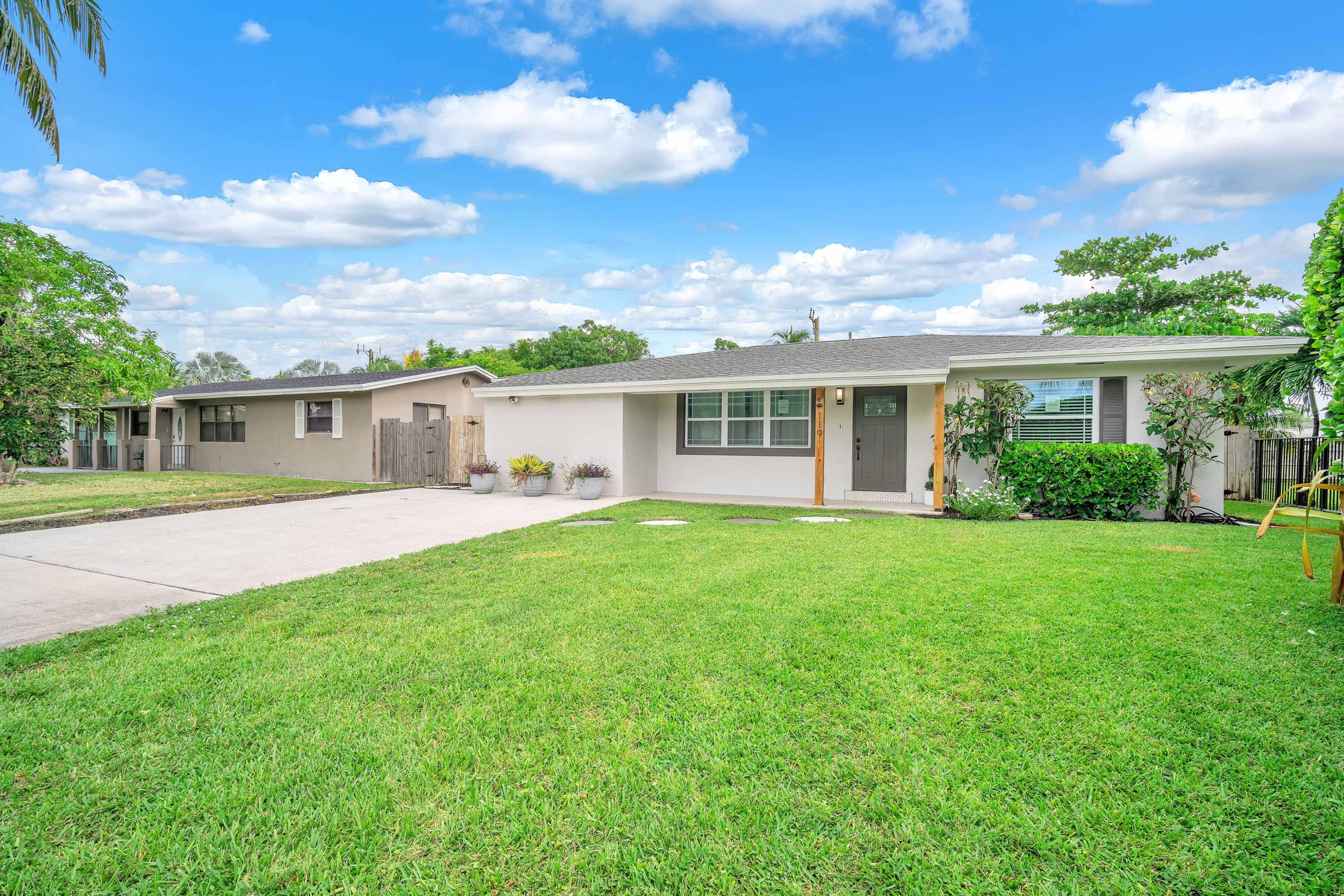 a view of house with yard and green space