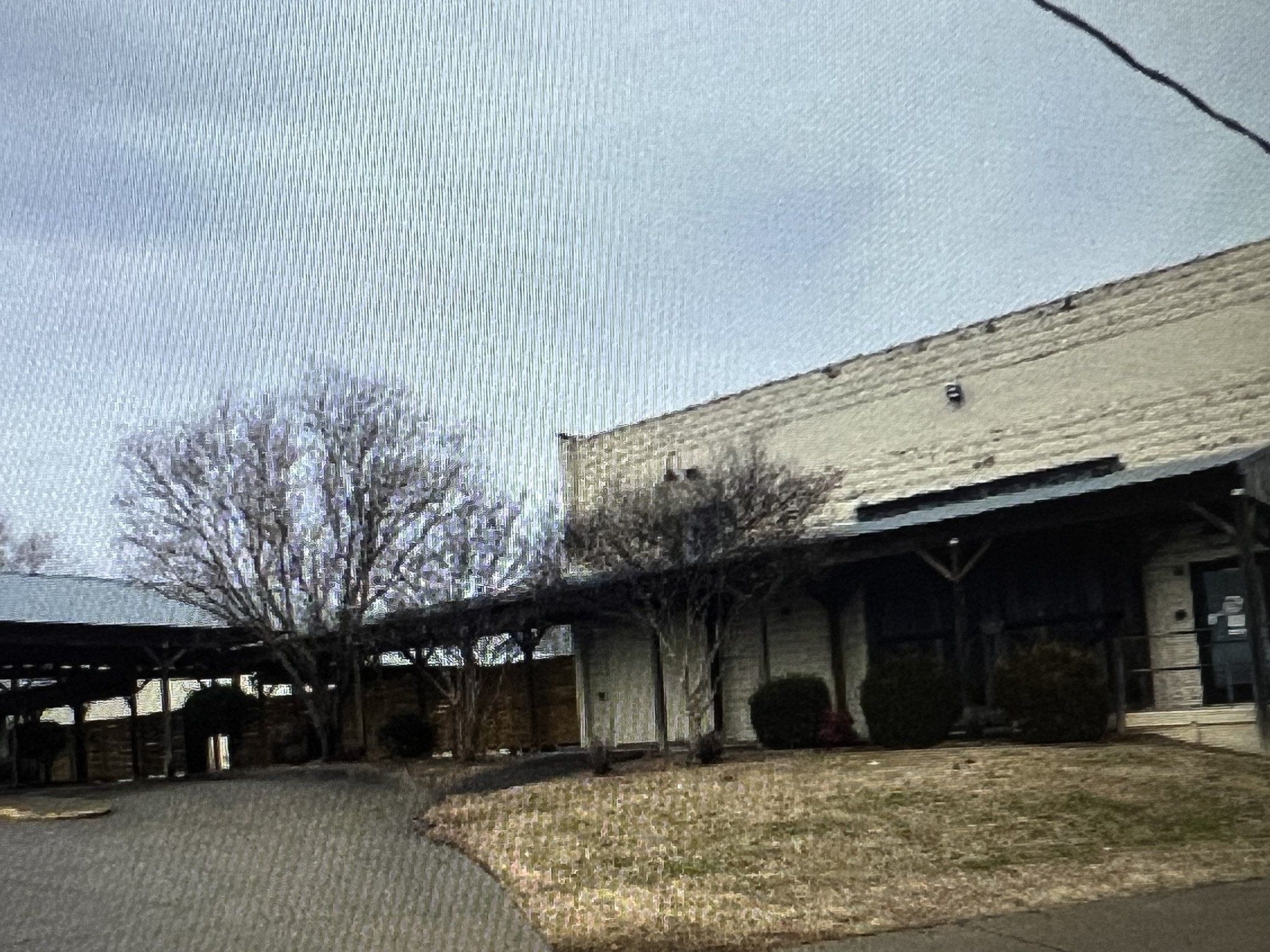 a front view of a building with parking space