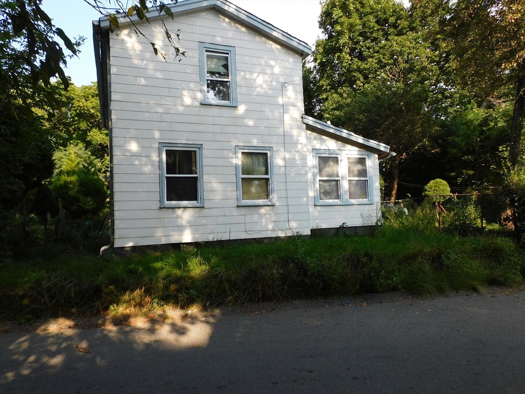 a front view of a house with a yard and outdoor seating