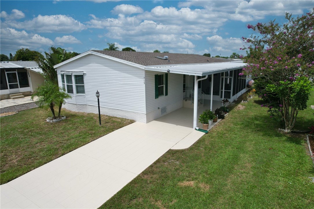 a view of a house with a backyard