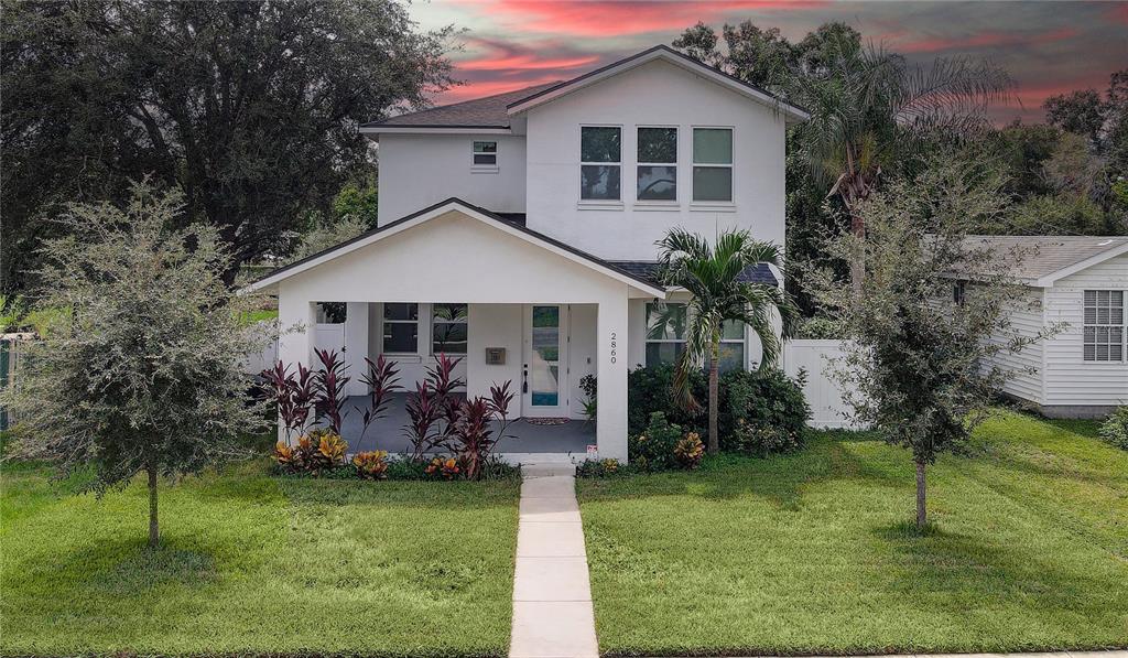 a front view of house with a garden