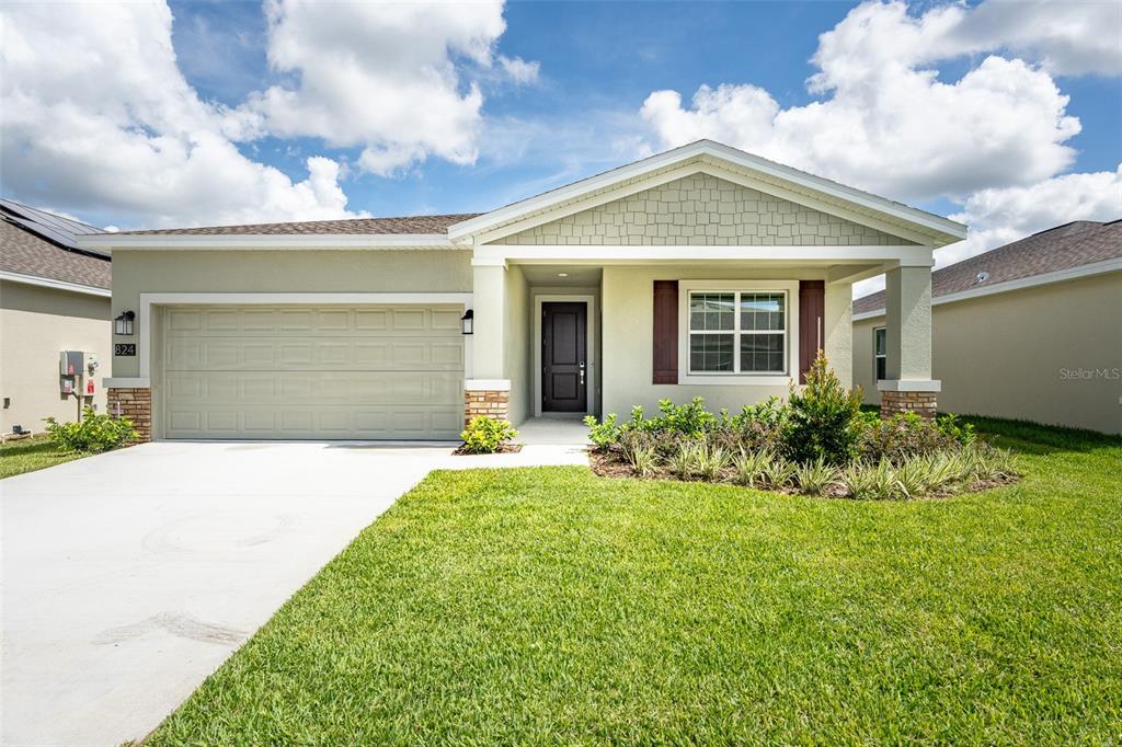 a front view of a house with a yard