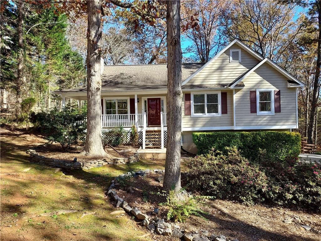 a front view of a house with a yard and potted plants