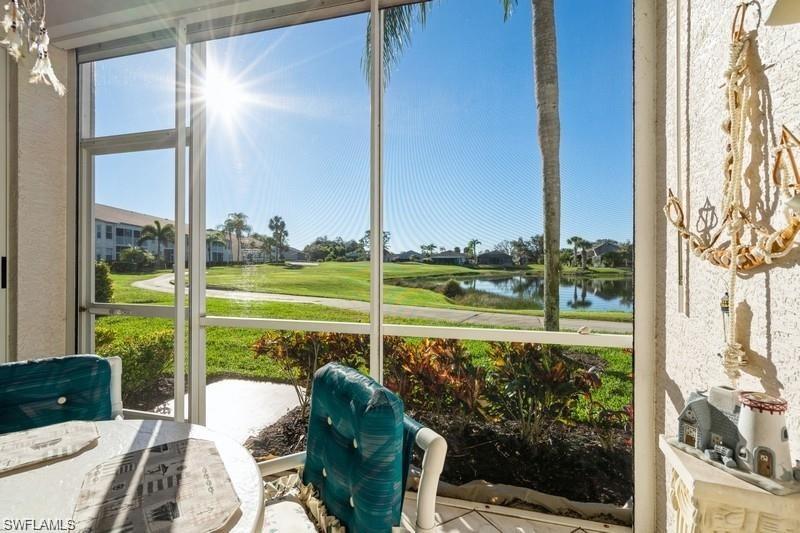 a view of a balcony with lake view and a floor to ceiling window