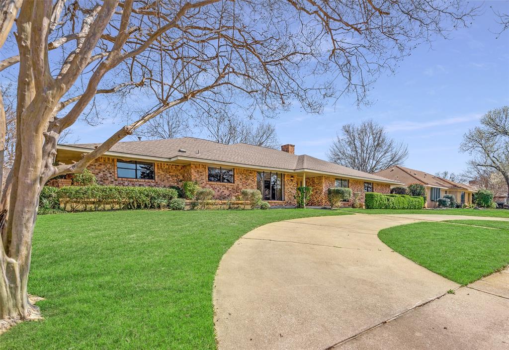 a front view of a house with a yard and pathway