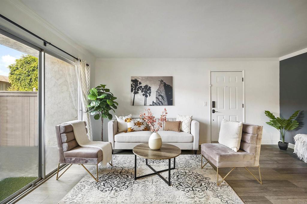 a living room with furniture and a potted plant