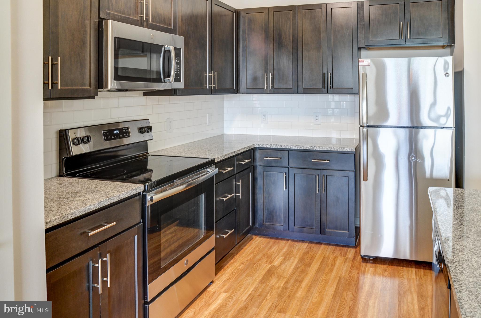 a kitchen with a refrigerator stove and microwave