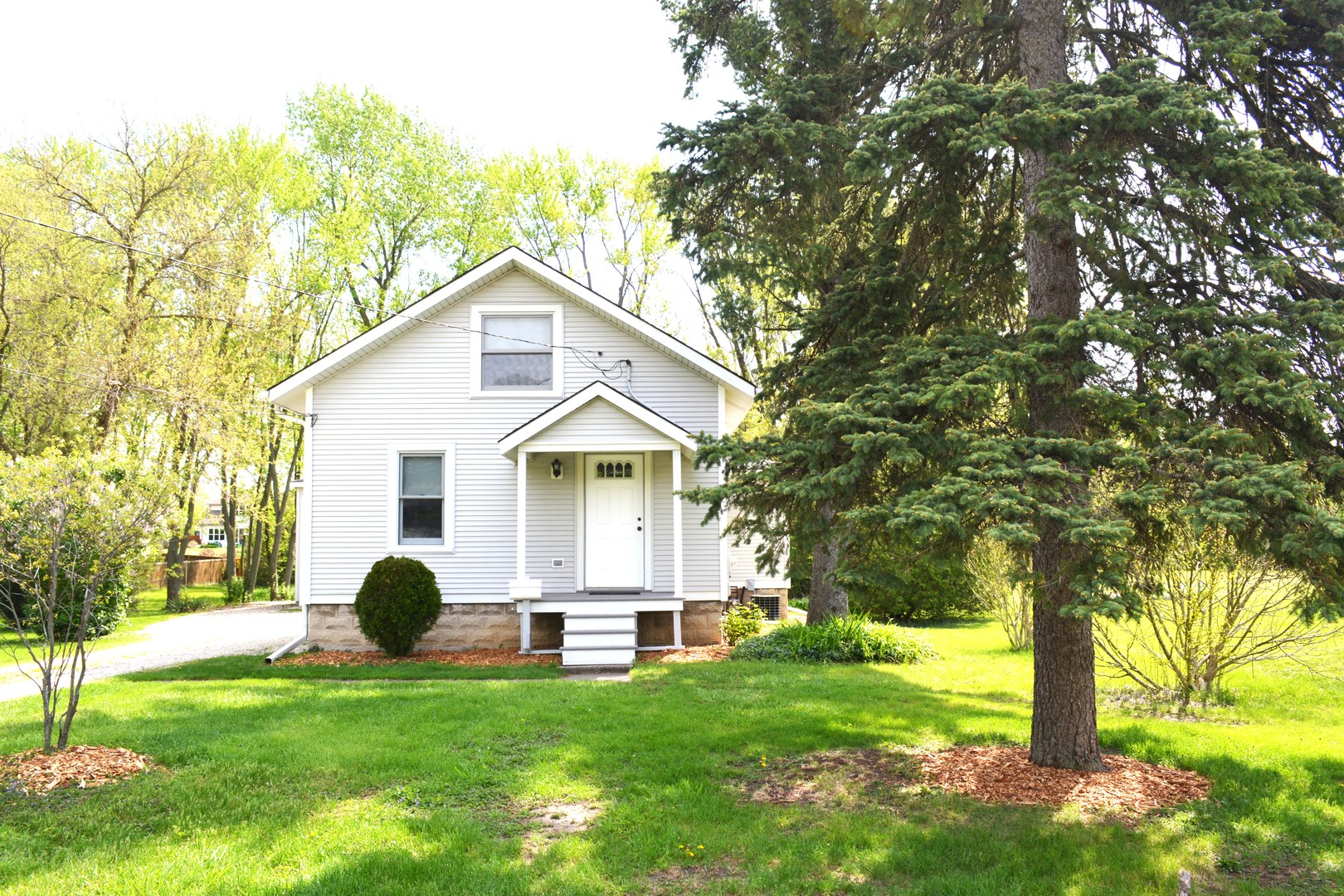 a front view of house with yard and green space