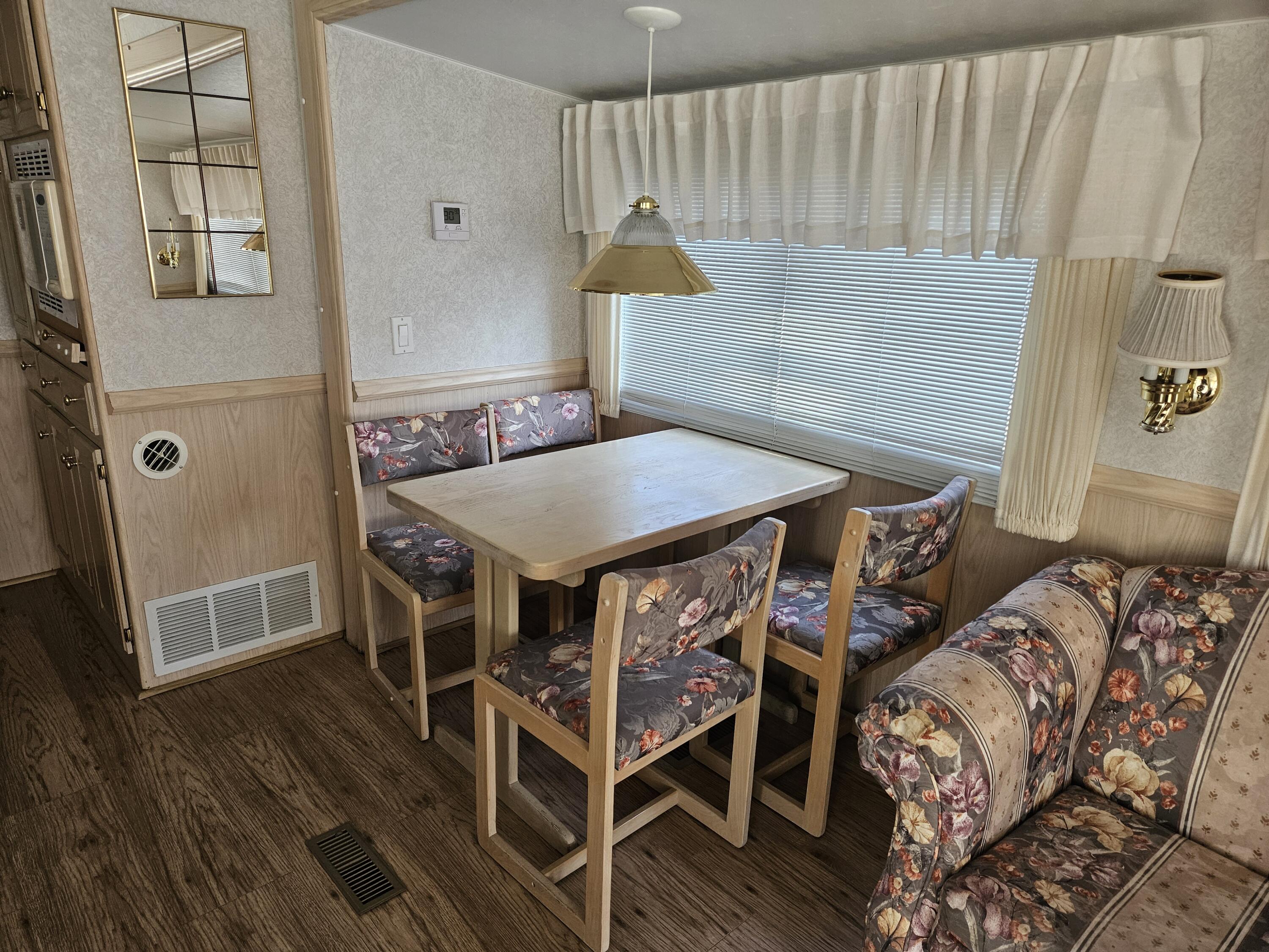 a dining room with furniture and wooden floor