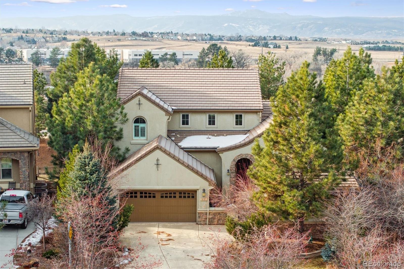 an aerial view of a house with a garden and lake view