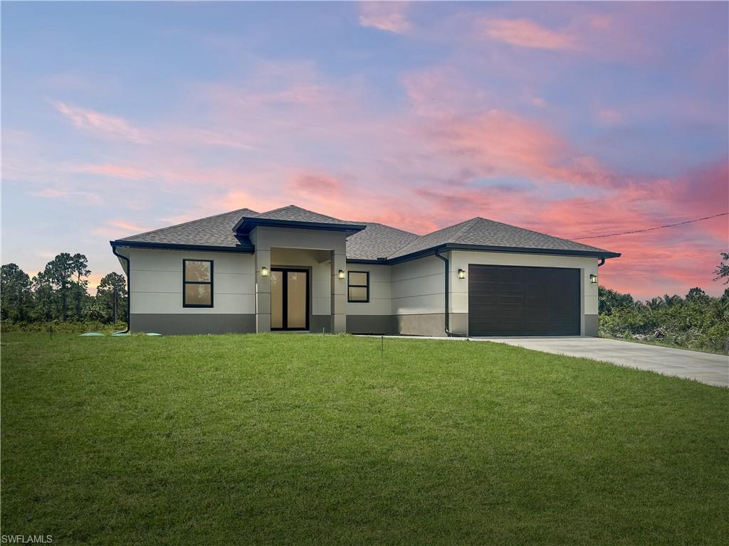 a front view of a house with a yard and garage