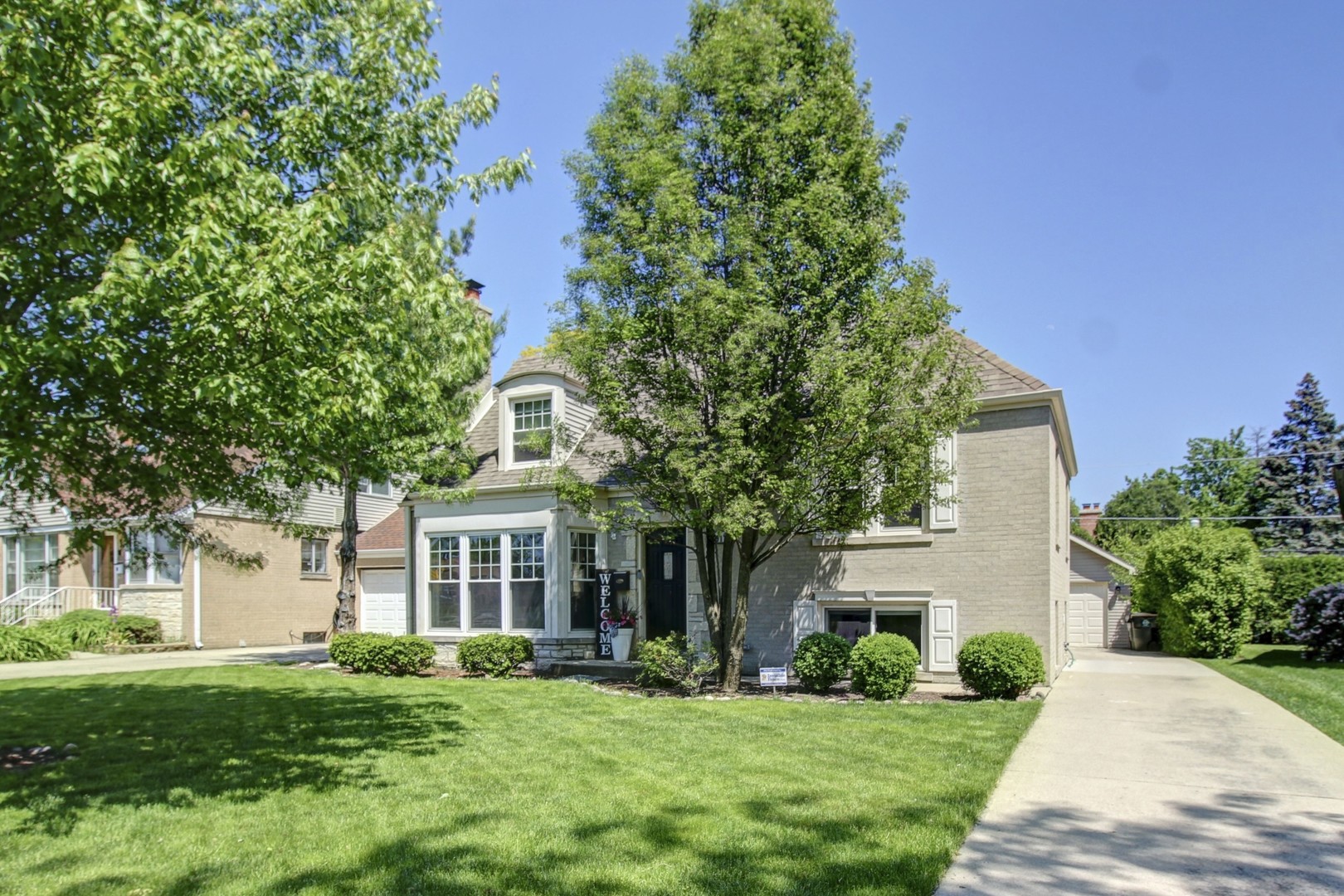 a front view of a house with a garden