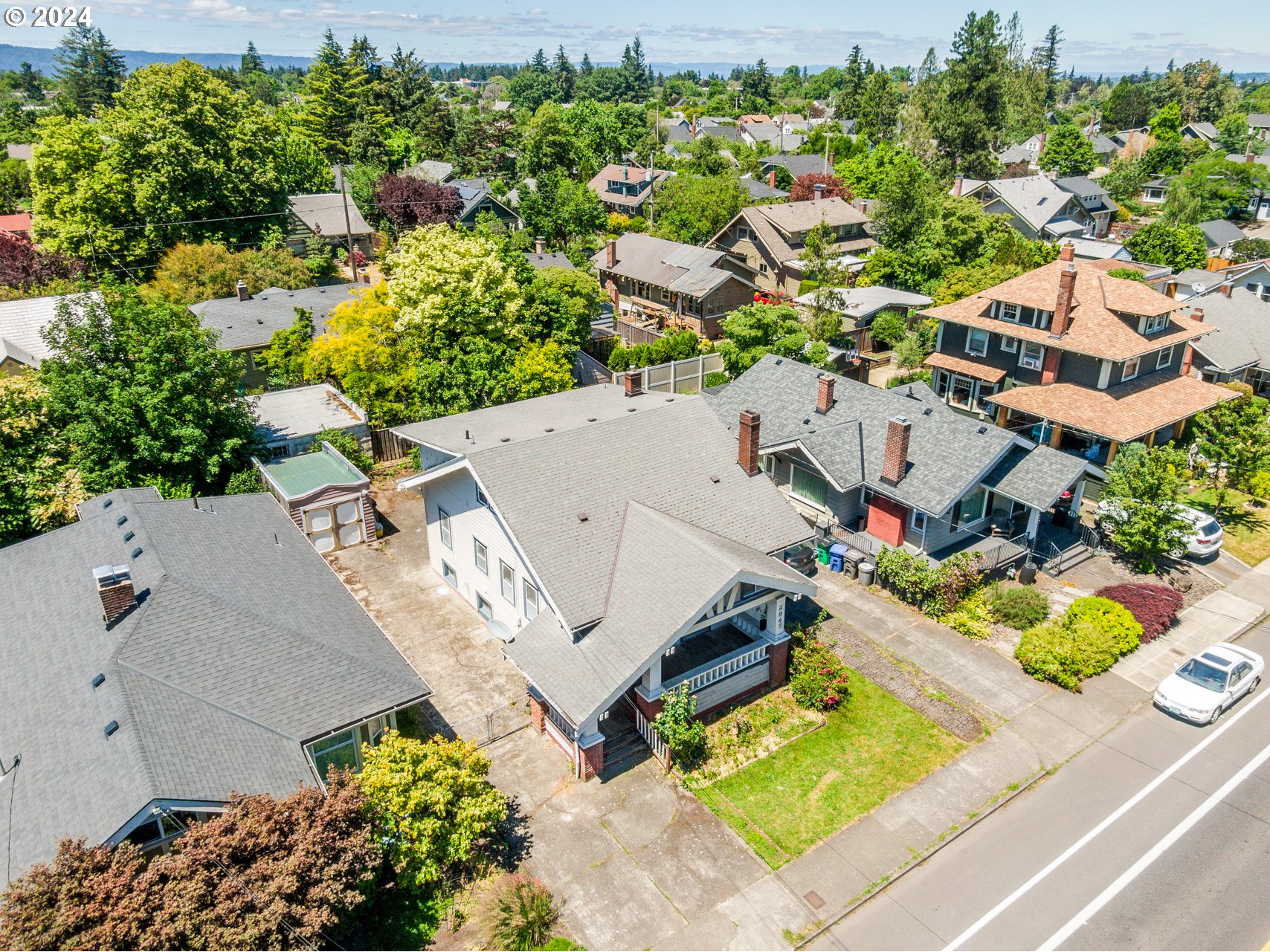 an aerial view of multiple houses with yard