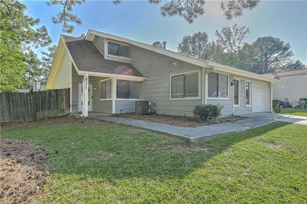 a front view of house with yard and green space