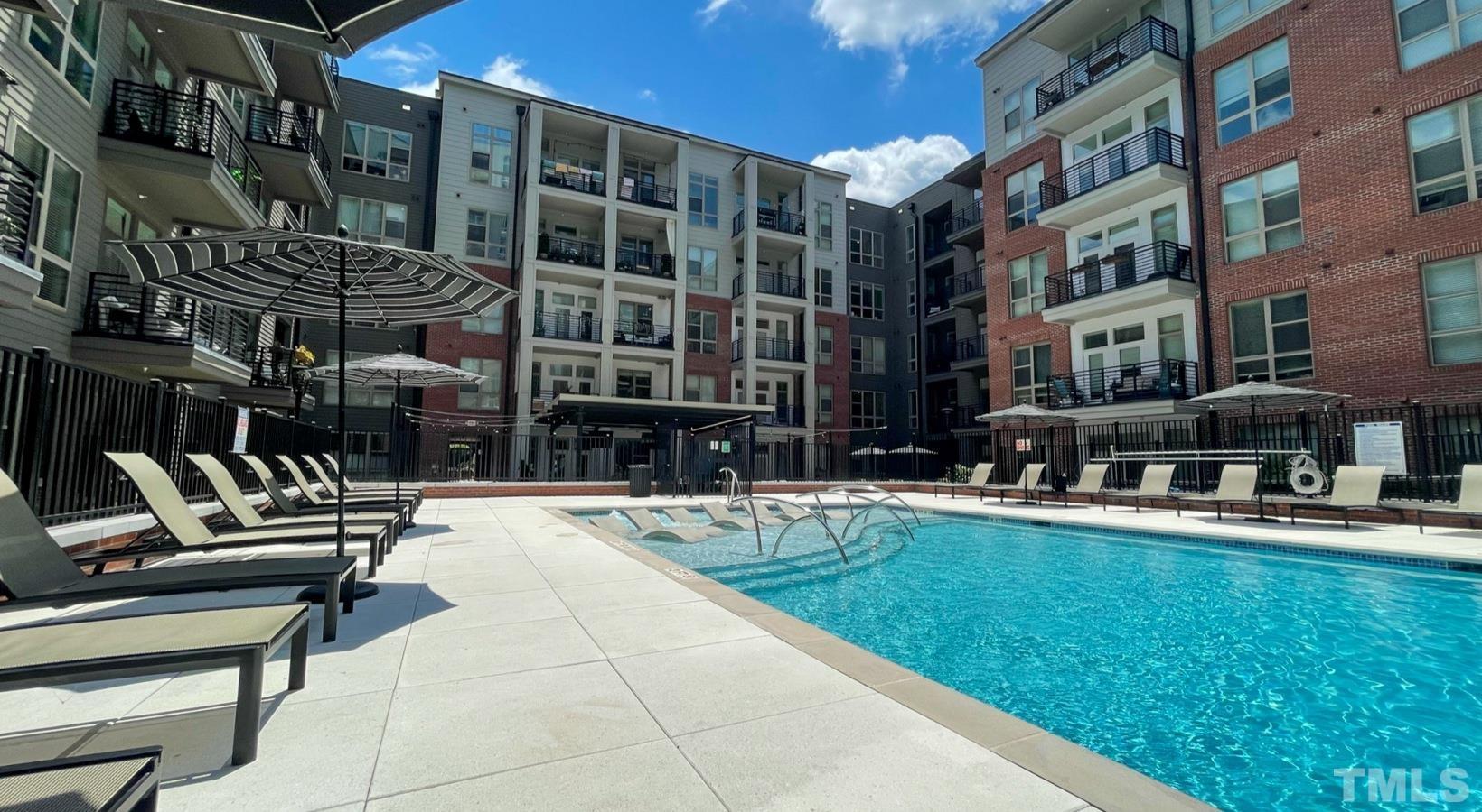 a view of swimming pool with outdoor seating and a patio