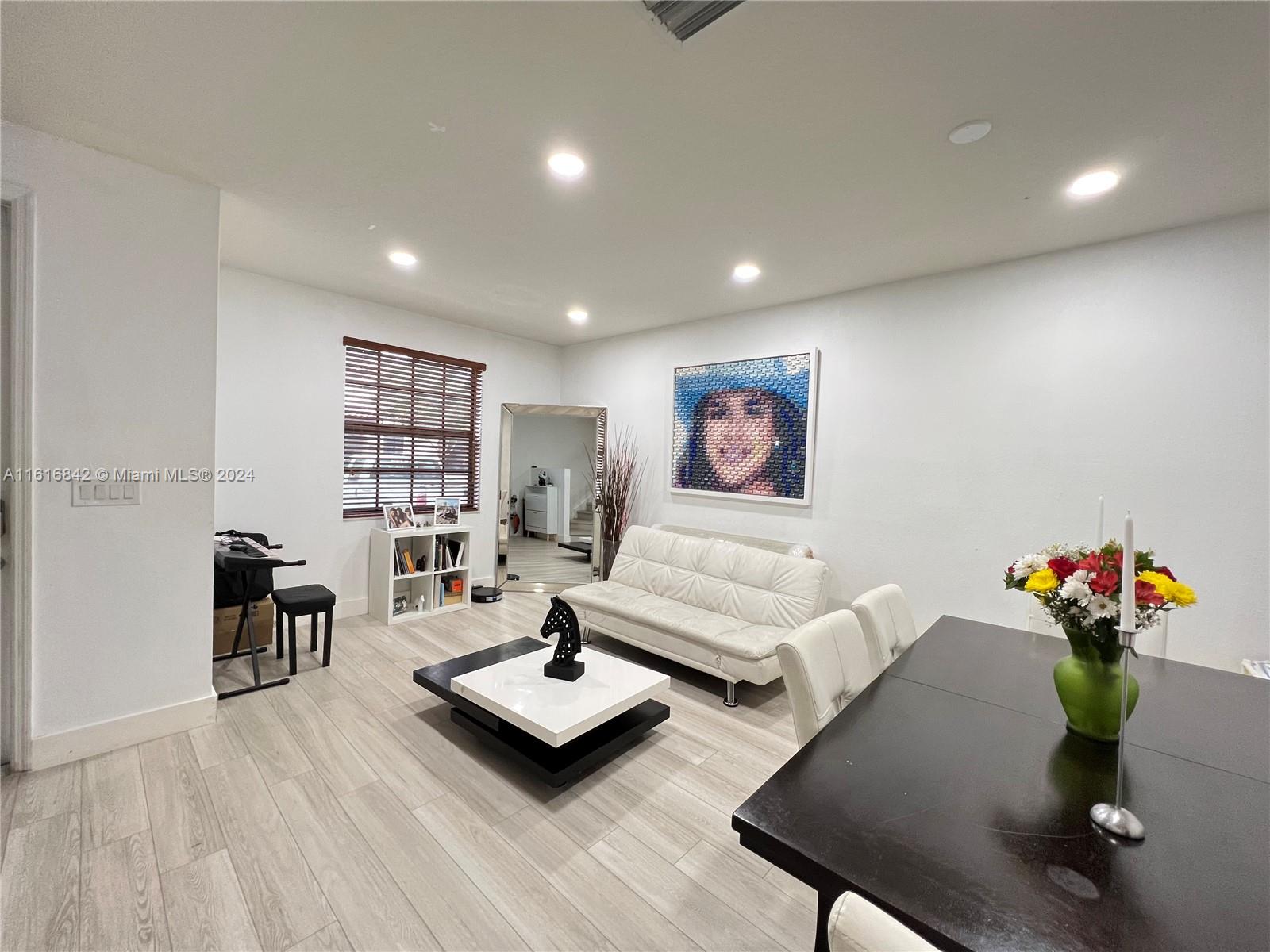 a living room with furniture and flowers