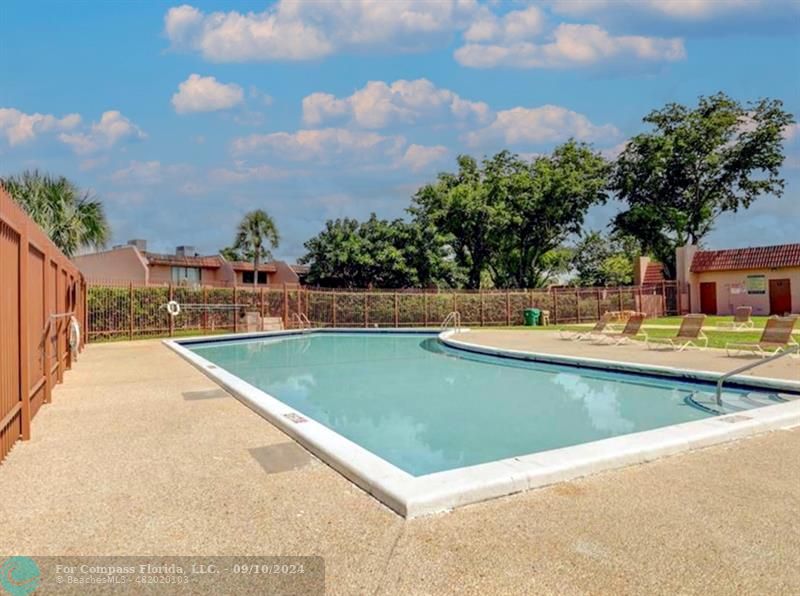 a view of swimming pool with a yard