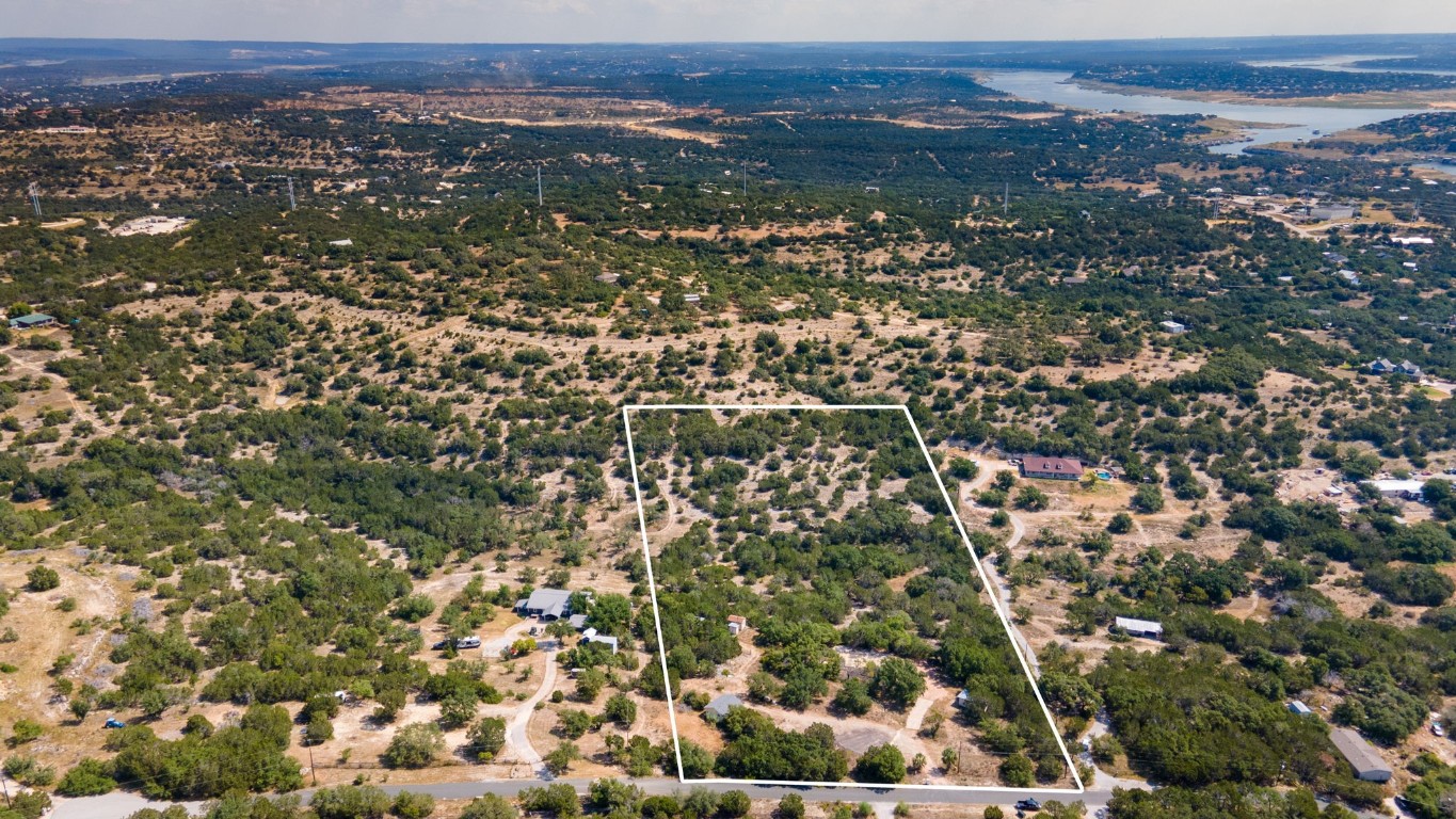 an aerial view of residential houses with city view