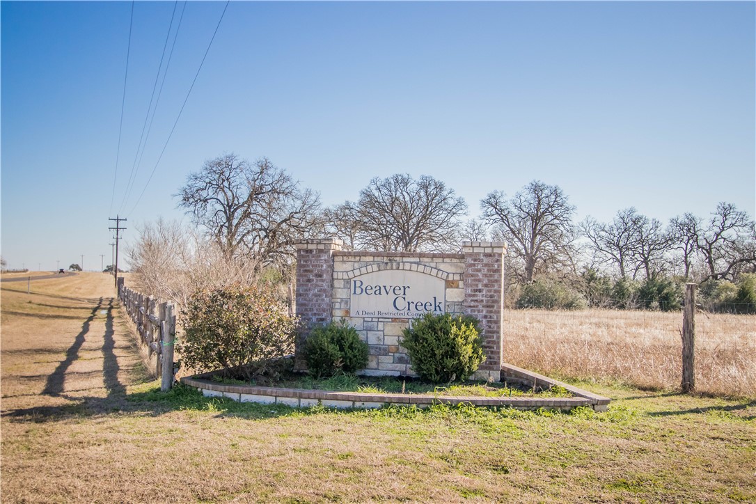 Community sign with a rural view