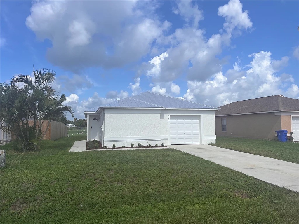 a front view of a house with a garden and yard