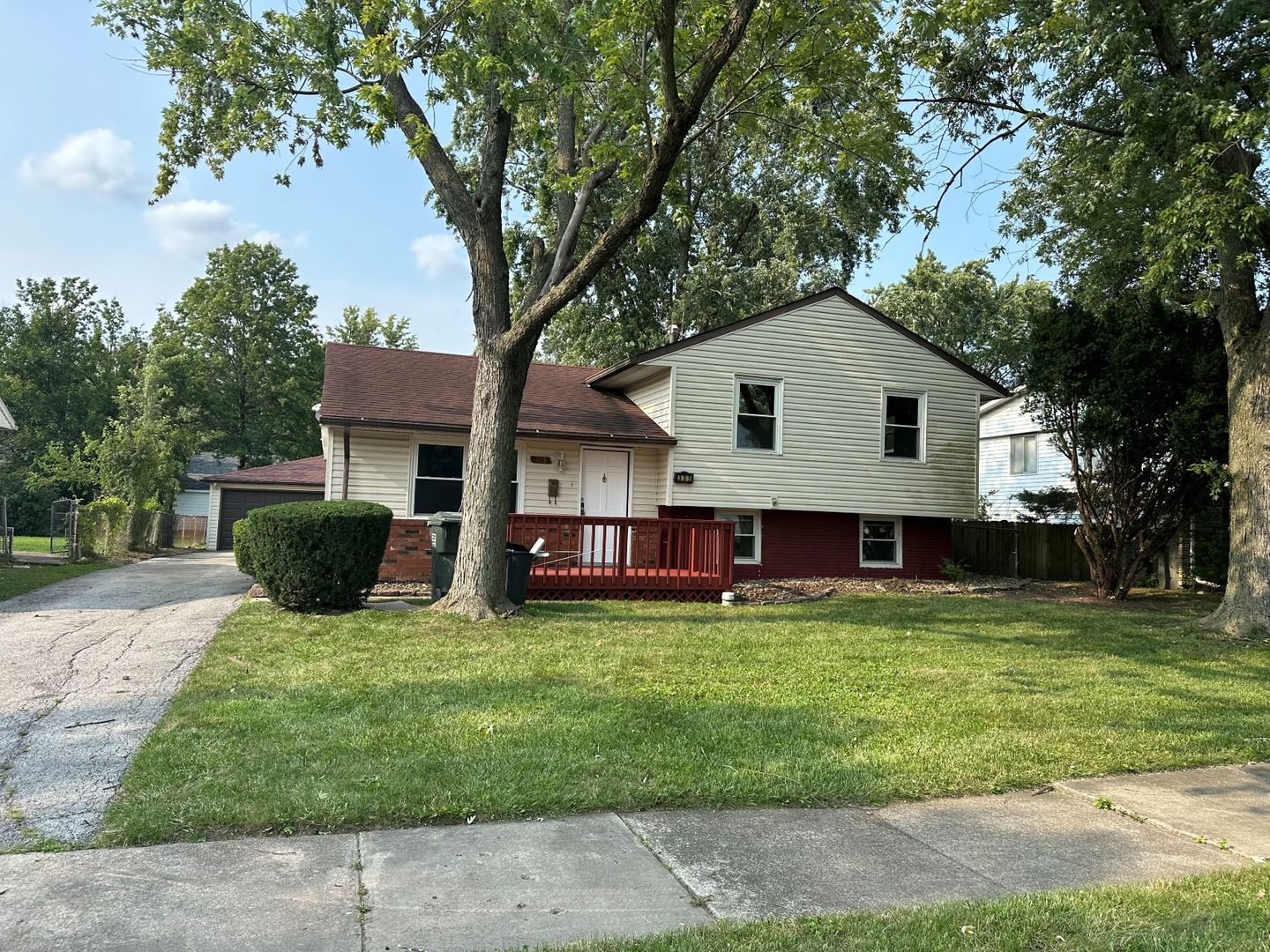 a view of a house with a yard and sitting area