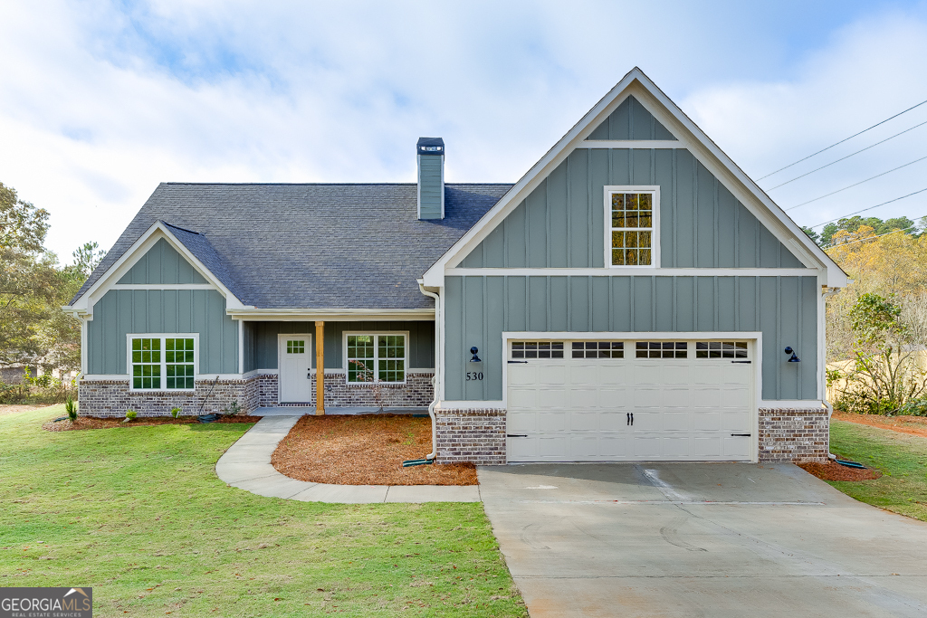 a view of a house with a yard patio and a yard