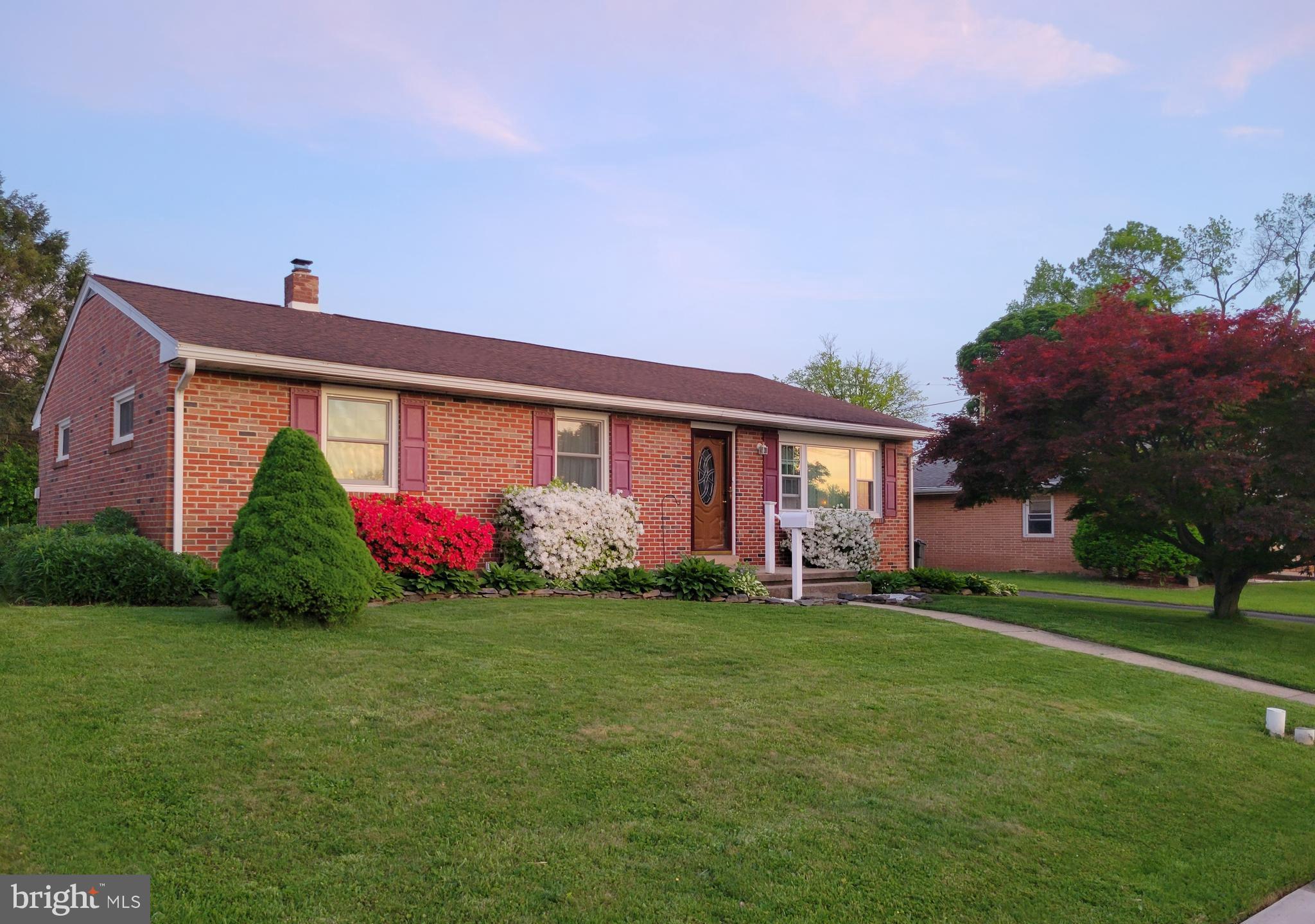 a front view of house with a garden