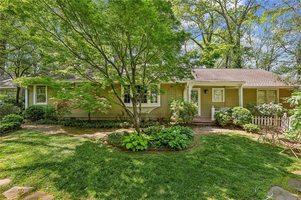 a front view of a house with a garden