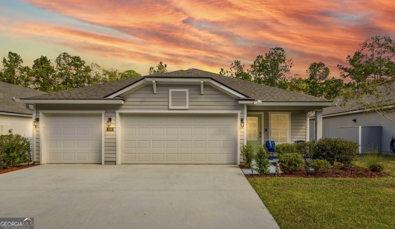 a front view of a house with a yard and garage