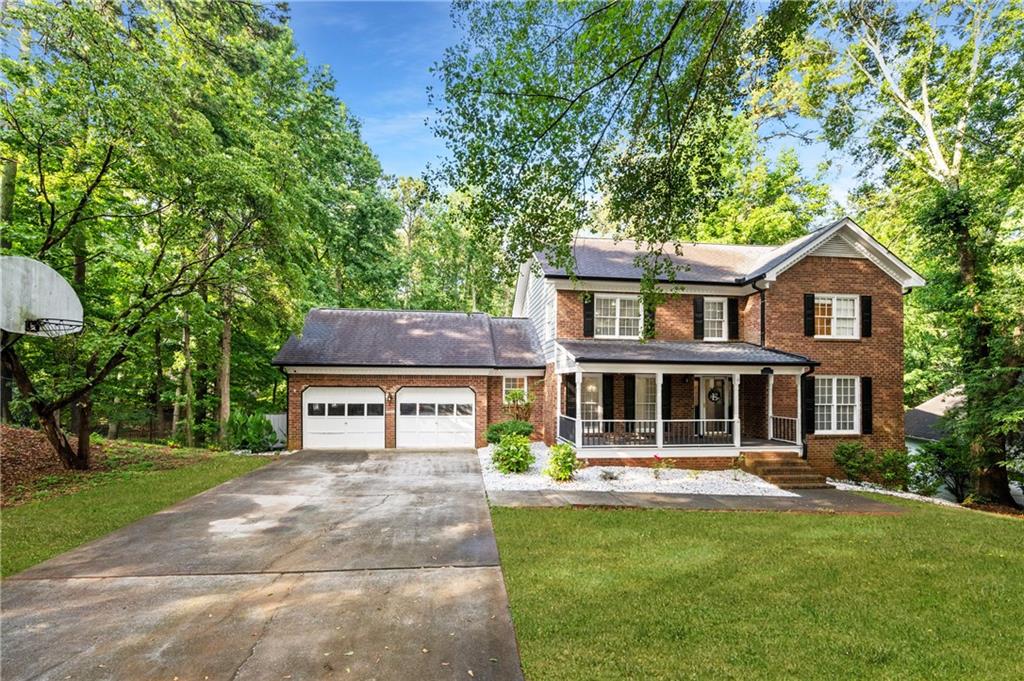 a front view of a house with yard and green space