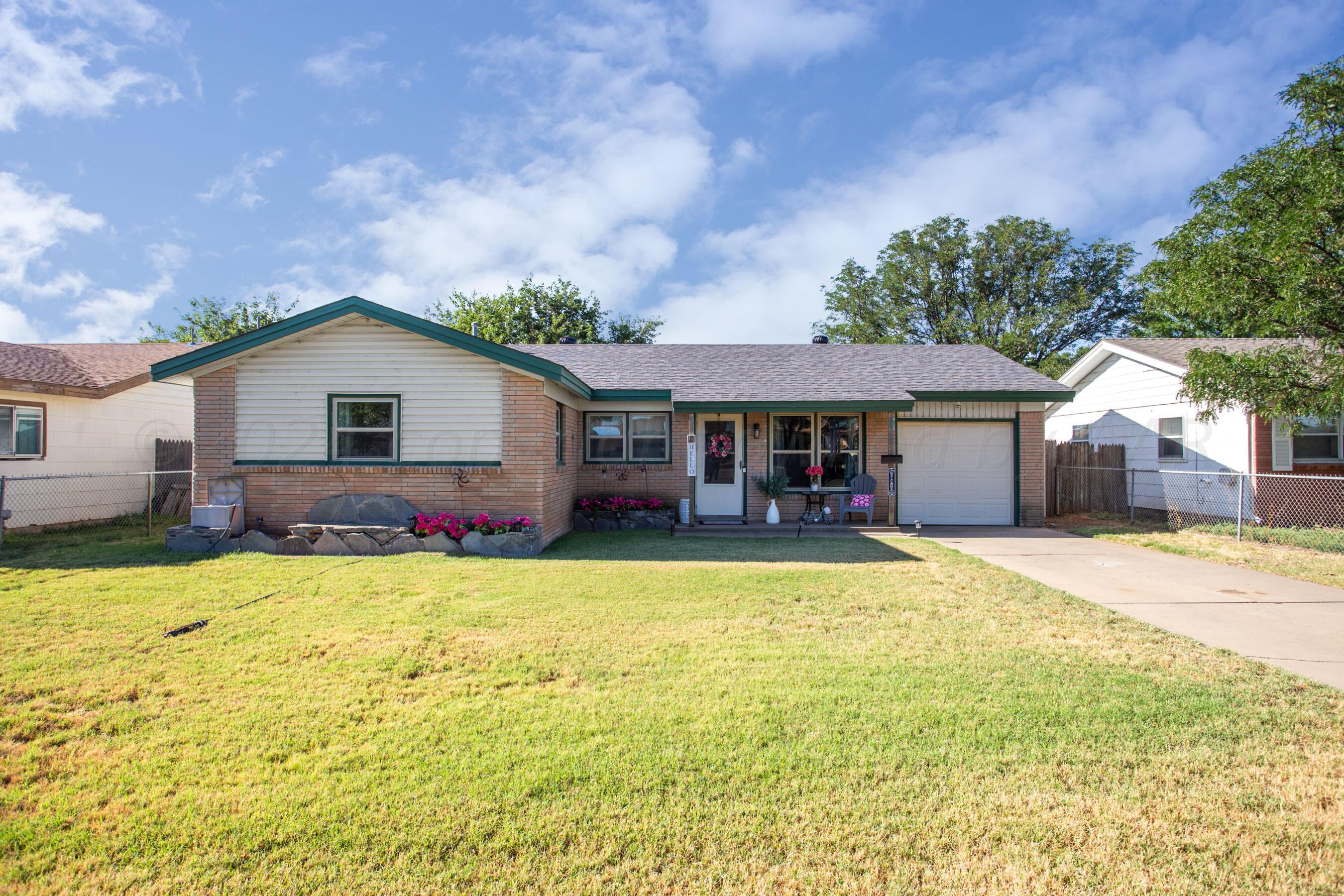 a front view of house with yard and entertaining space