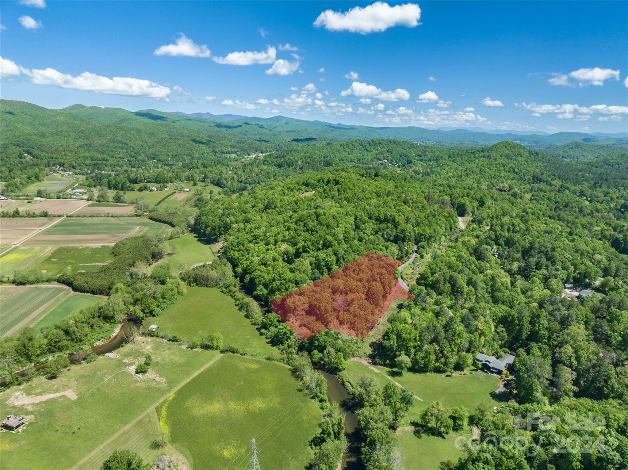 a view of a big yard with lots of green space