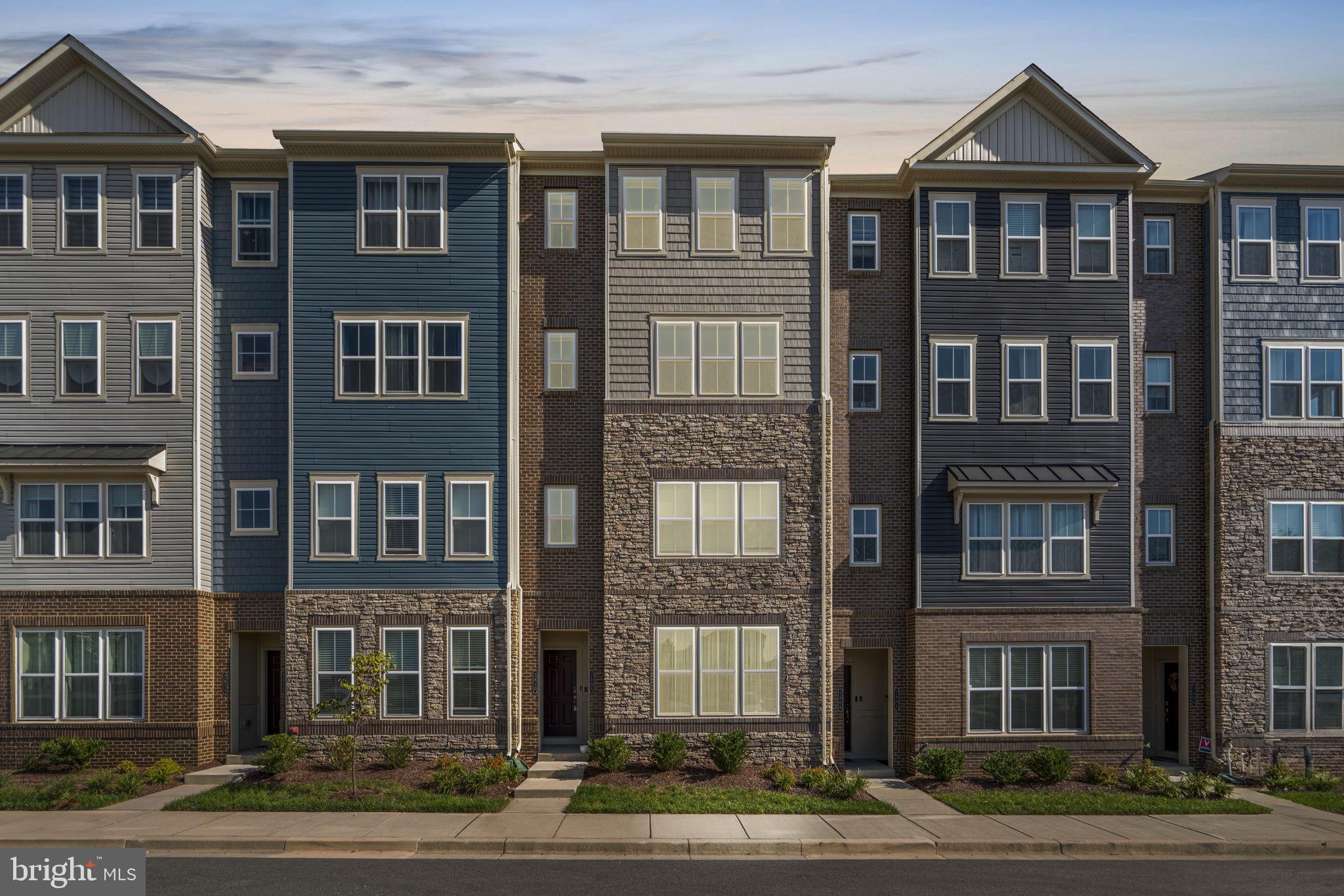 a front view of a residential apartment building with a yard