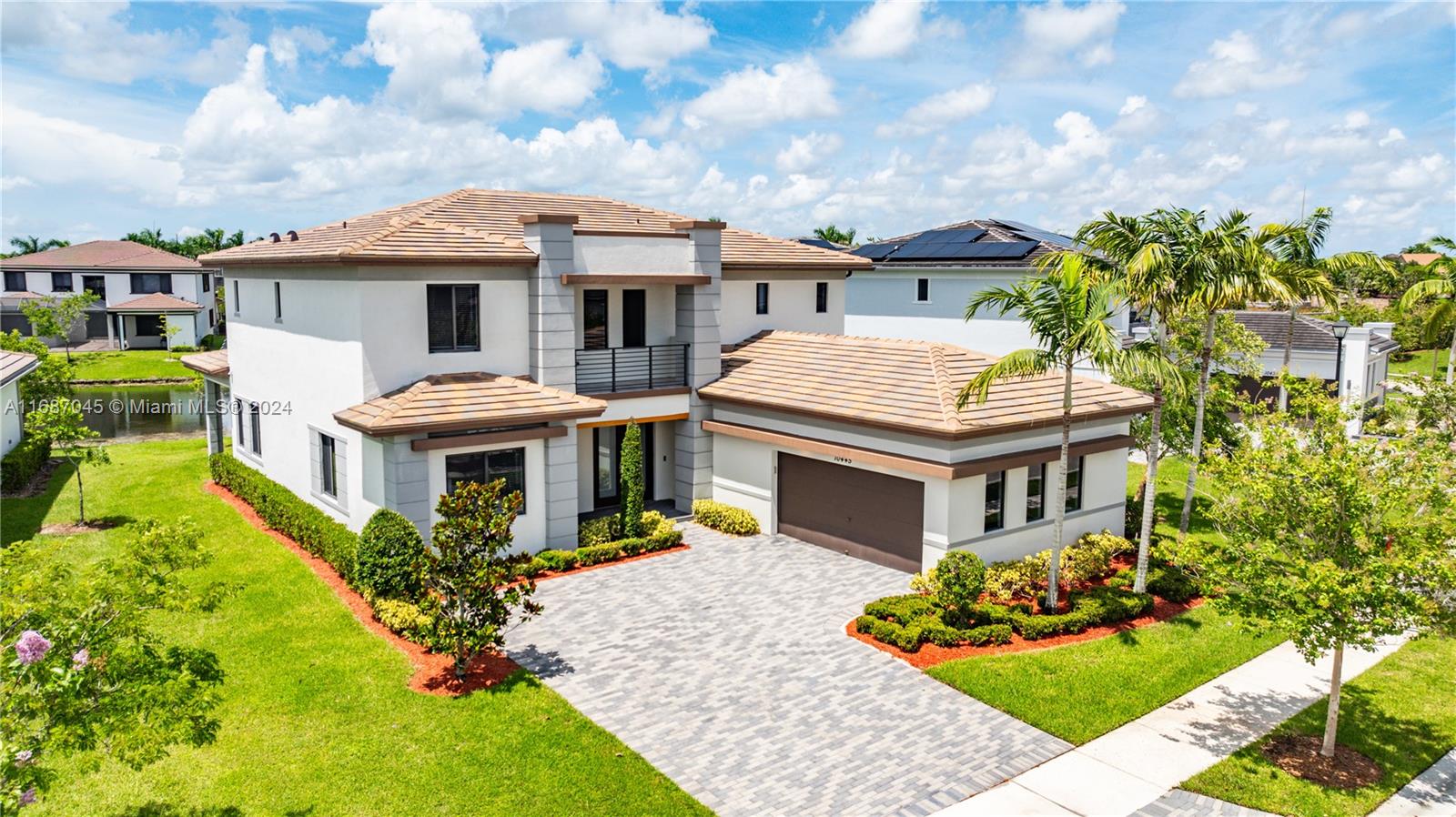 a aerial view of a house with a yard and potted plants