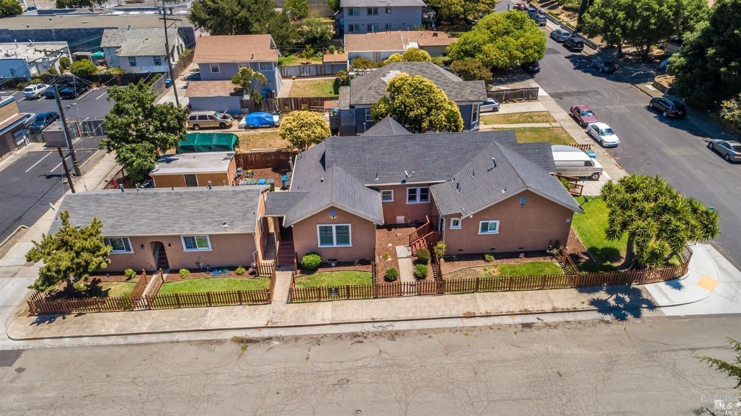 an aerial view of multiple houses with a yard