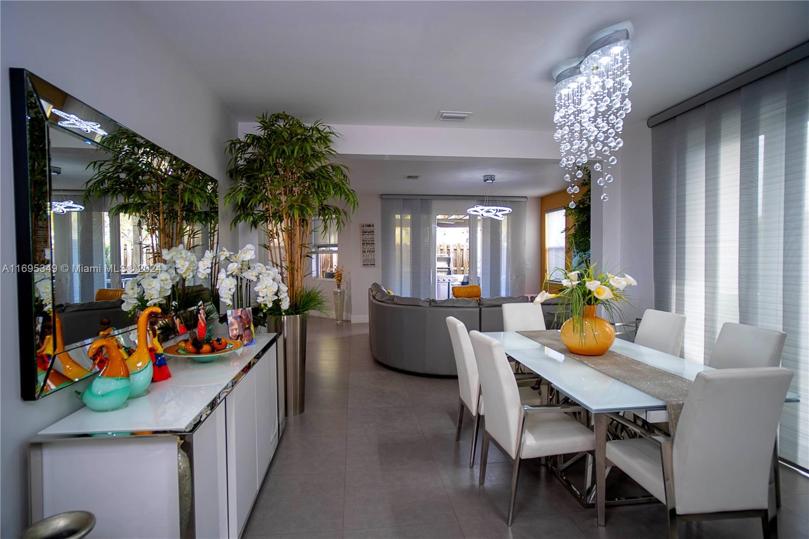 a living room filled with furniture and a chandelier